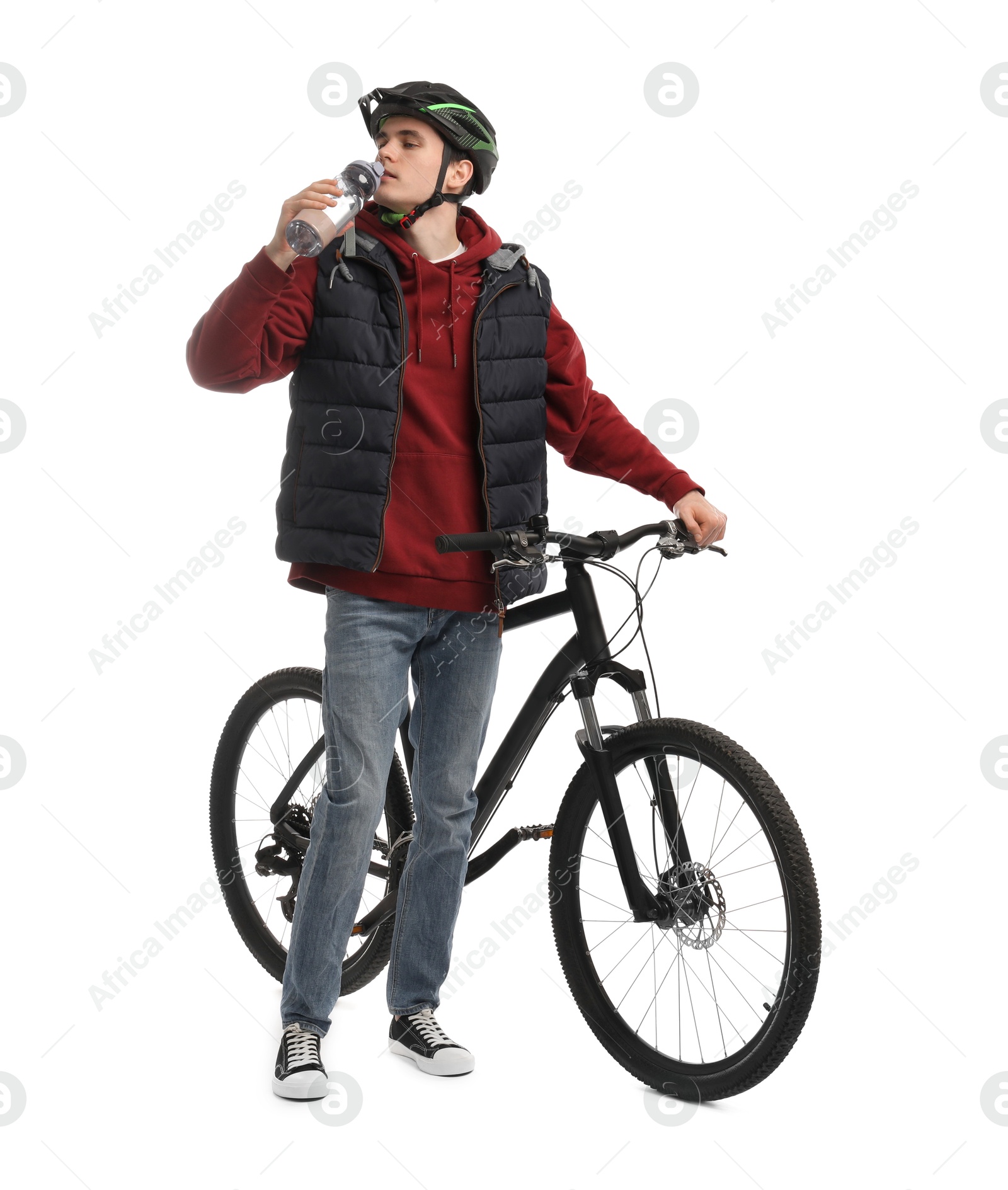 Photo of Man in helmet with bicycle drinking water on white background