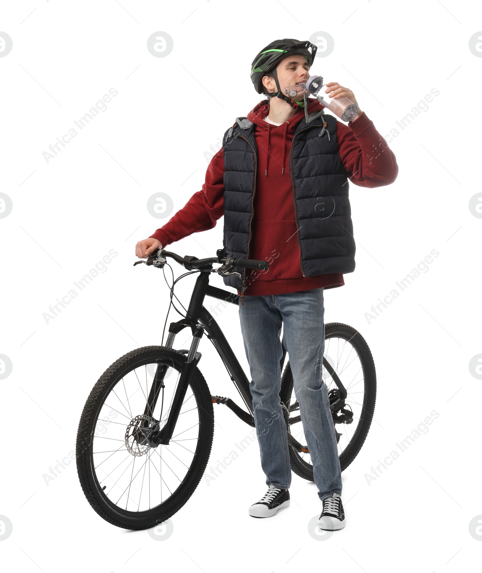Photo of Man in helmet with bicycle drinking water on white background