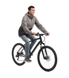 Smiling man riding bicycle on white background