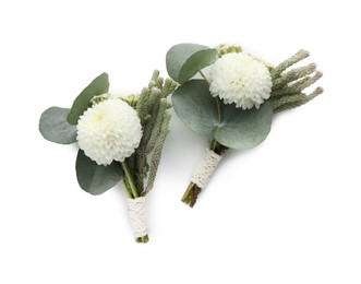 Photo of Two small stylish boutonnieres isolated on white, top view