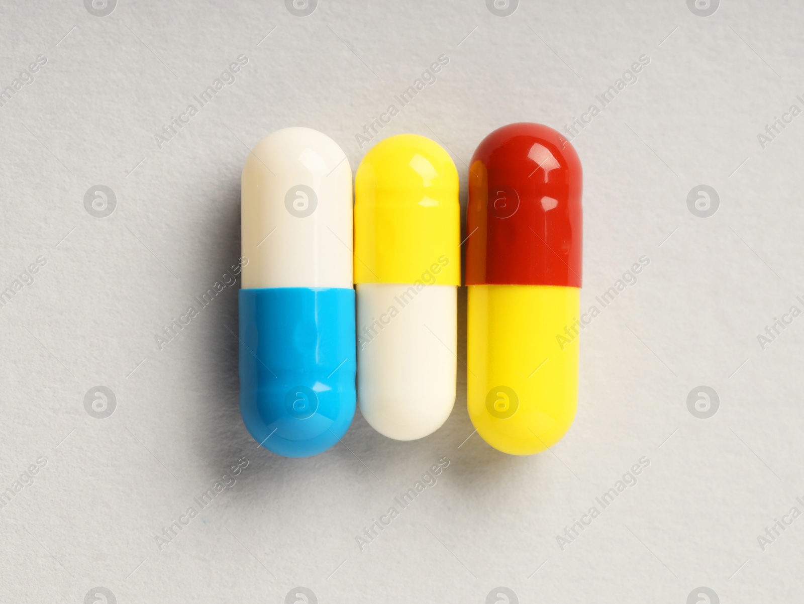 Photo of Antibiotic pills on grey background, top view. Medicinal treatment