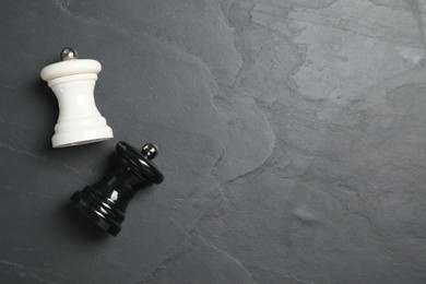 Photo of Salt and pepper shakers on grey textured table, flat lay. Space for text