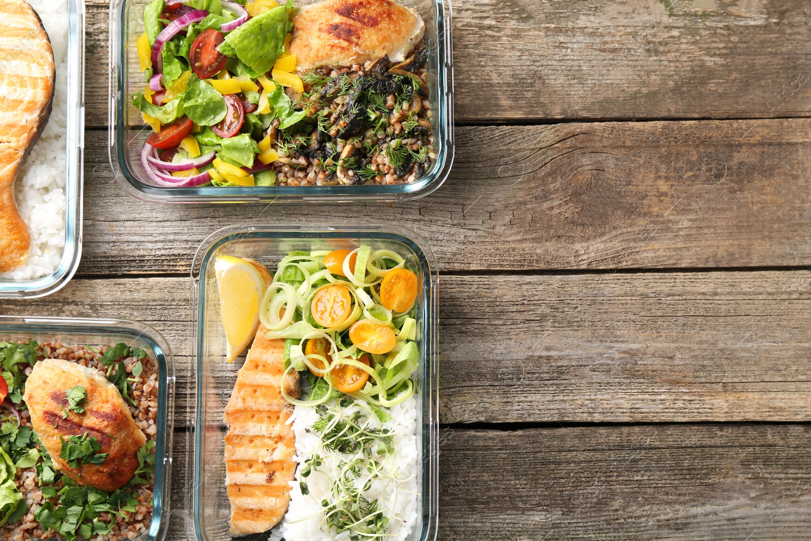 Photo of Healthy meal. Containers with different products on wooden table, flat lay. Space for text