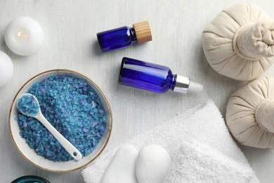 Flat lay composition with spa products on light wooden table