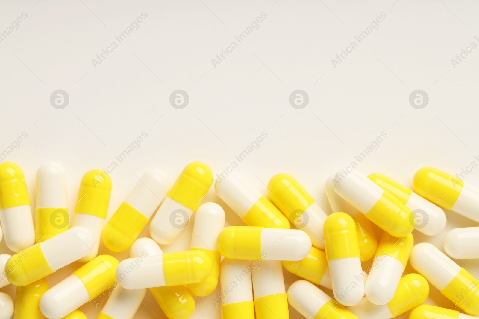 Photo of Antibiotic pills on white background, top view. Space for text