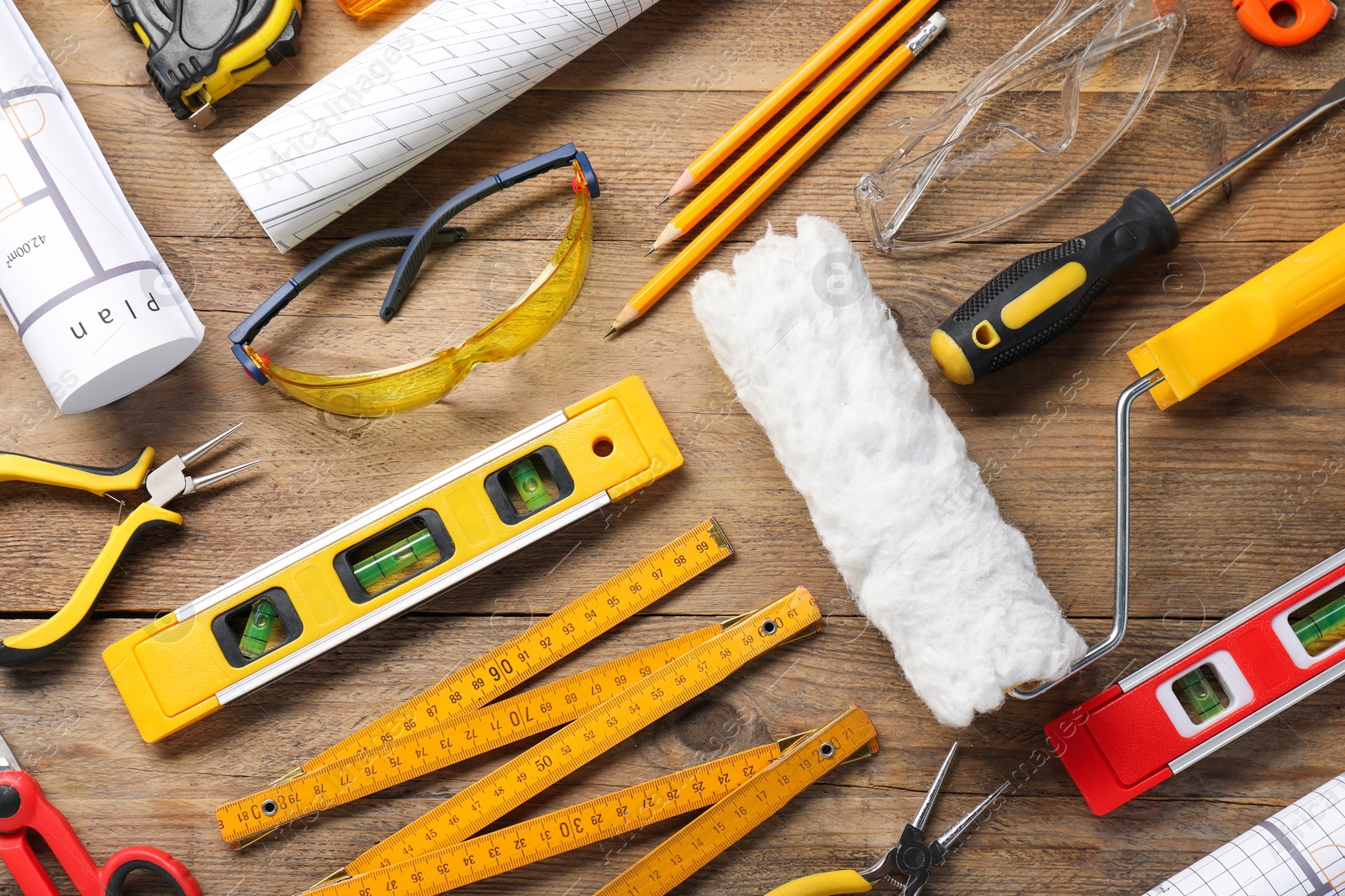 Photo of Flat lay composition with building level and other construction tools on wooden table