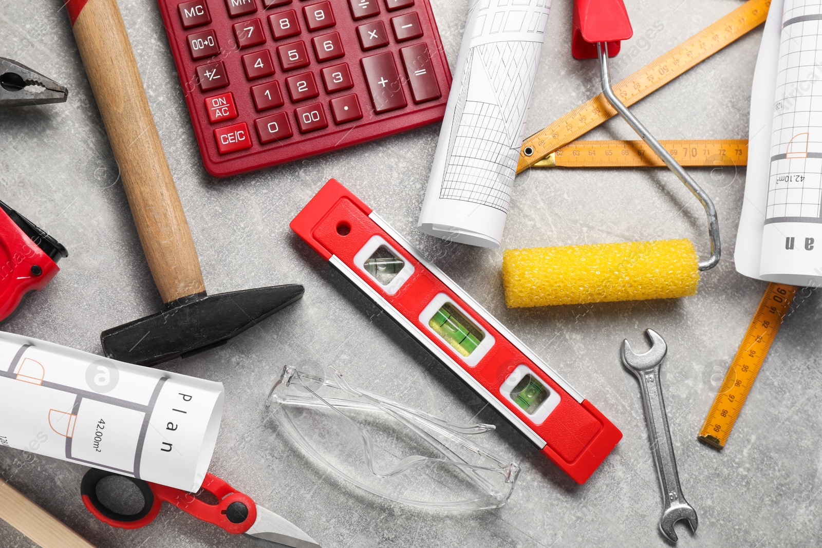 Photo of Flat lay composition with building level and other construction tools on grey table