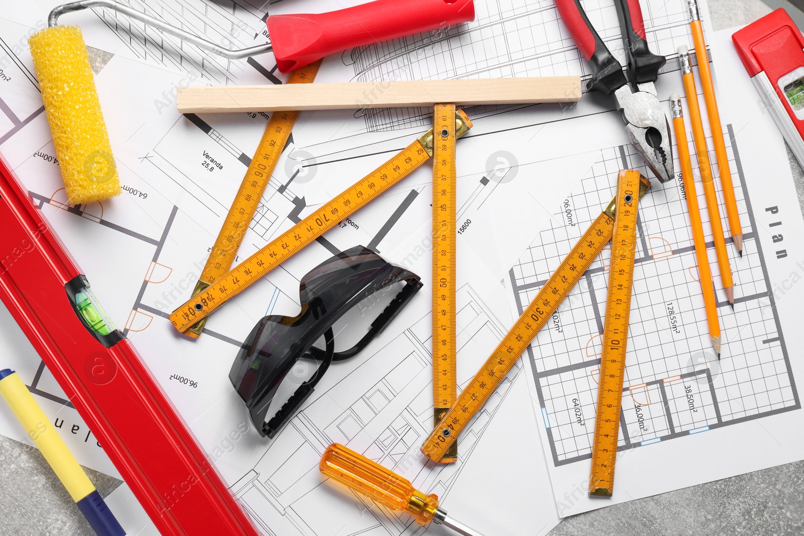 Photo of Flat lay composition with building level and other construction tools on grey table