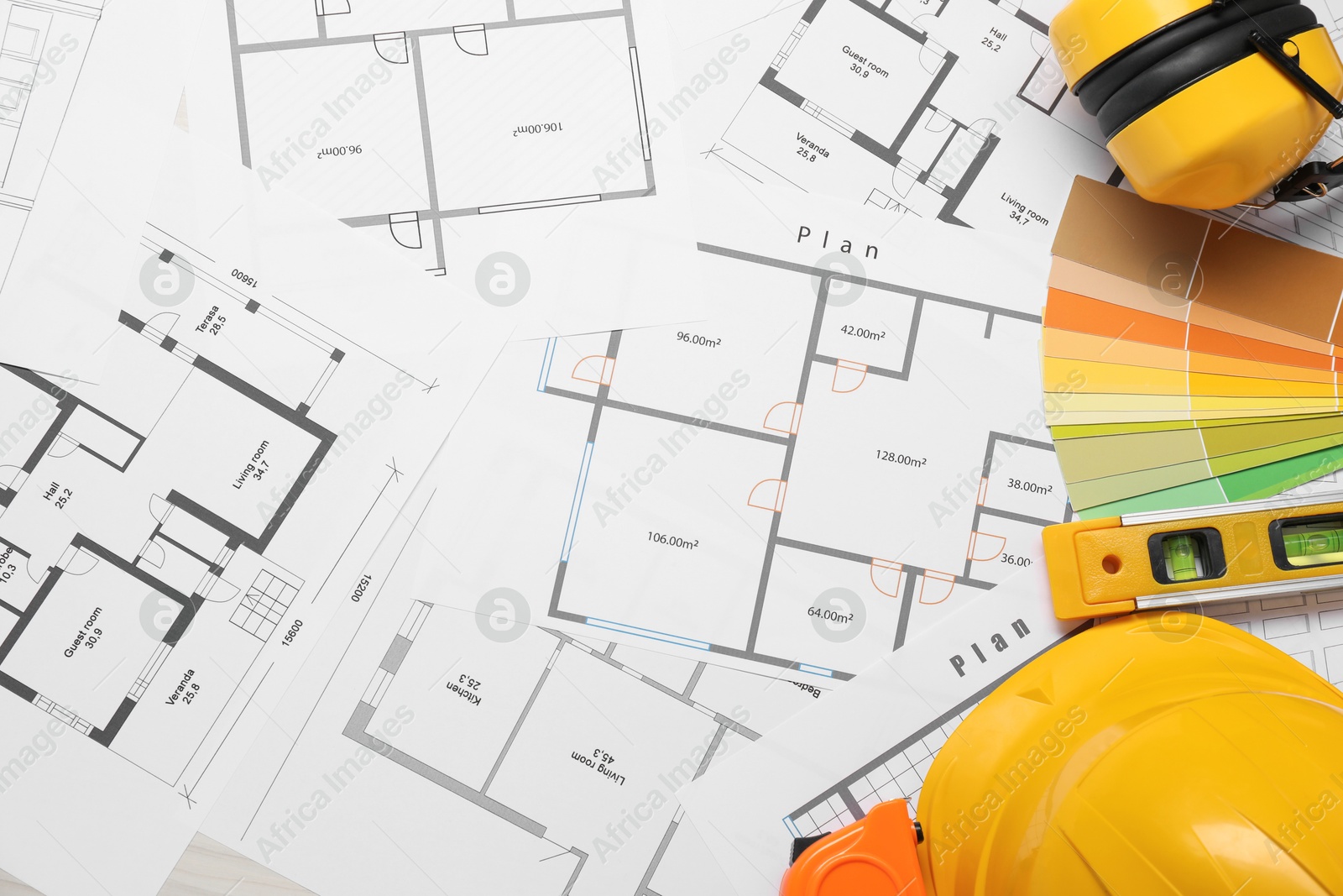 Photo of Flat lay composition with building level and other construction tools on papers