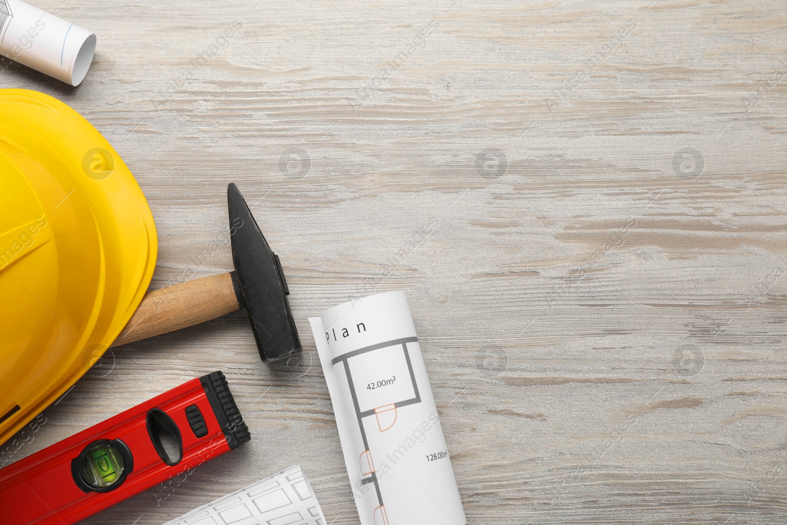 Photo of Flat lay composition with building level and other construction tools on white wooden table, space for text