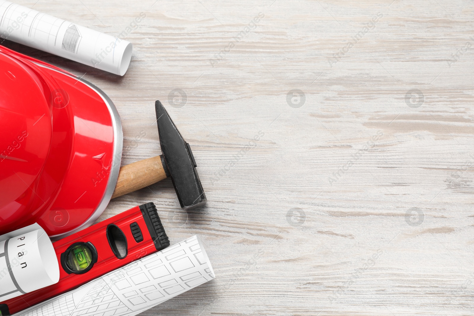 Photo of Flat lay composition with building level and other construction tools on white wooden table, space for text