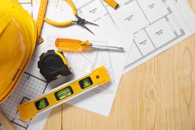 Photo of Flat lay composition with building level and other different construction tools on wooden background