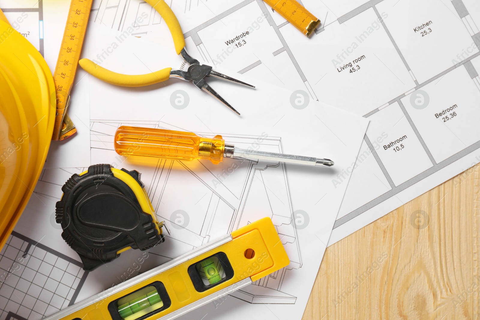 Photo of Flat lay composition with building level and other different construction tools on wooden background