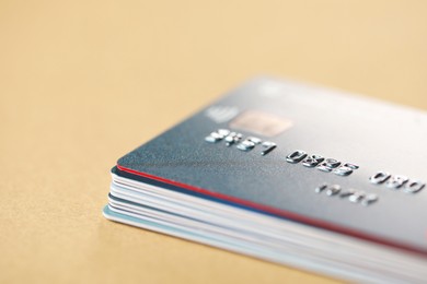 Photo of Stack of credit cards on table, closeup. Space for text