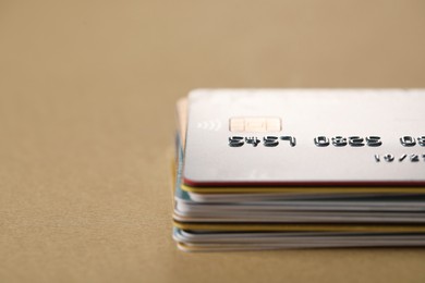 Photo of Stack of credit cards on table, closeup. Space for text