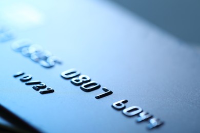 Photo of One credit card on blurred background, macro view