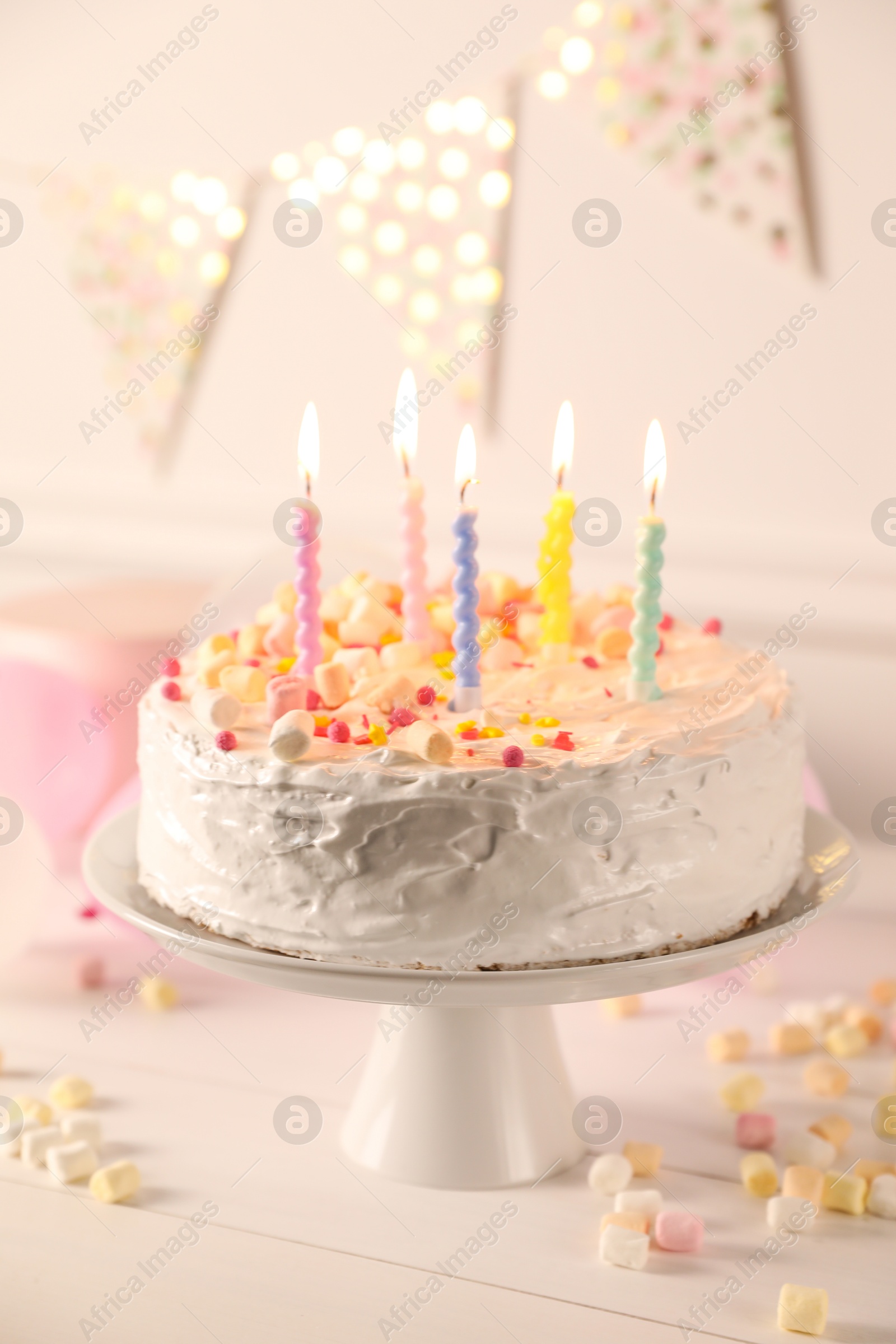 Photo of Tasty Birthday cake with burning candles on white table, closeup