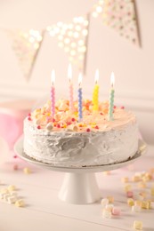 Photo of Tasty Birthday cake with burning candles on white table, closeup