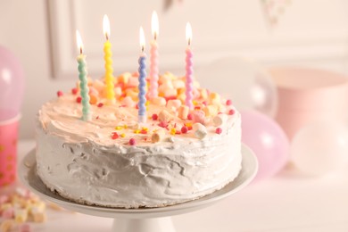 Photo of Tasty Birthday cake with burning candles on table, closeup
