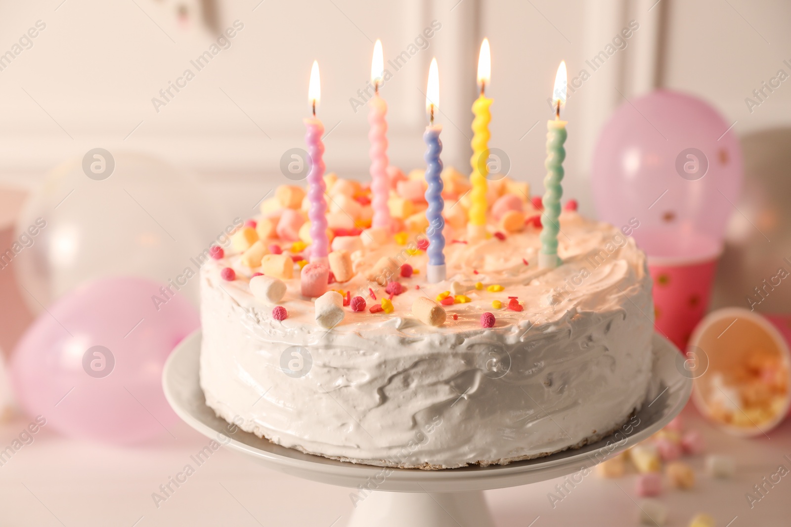 Photo of Tasty Birthday cake with burning candles on table, closeup