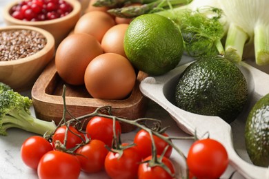 Photo of Many different healthy food on light table, closeup