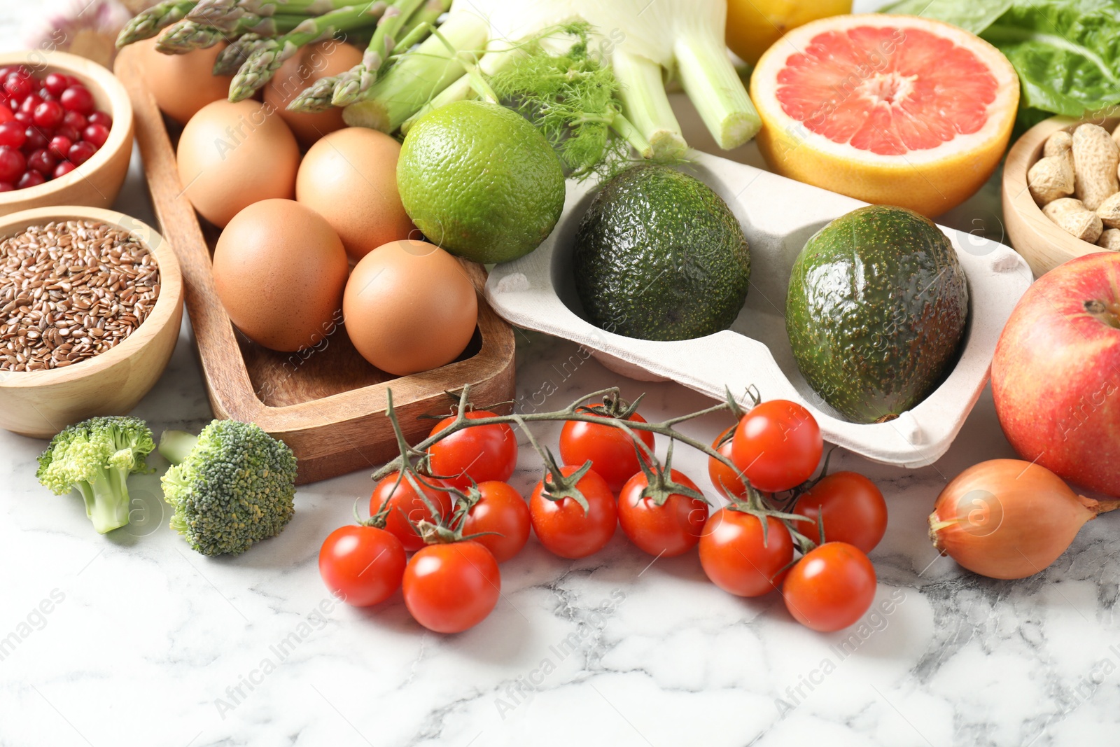 Photo of Many different healthy food on light marble table, closeup