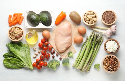 Many different healthy food on white wooden table, flat lay