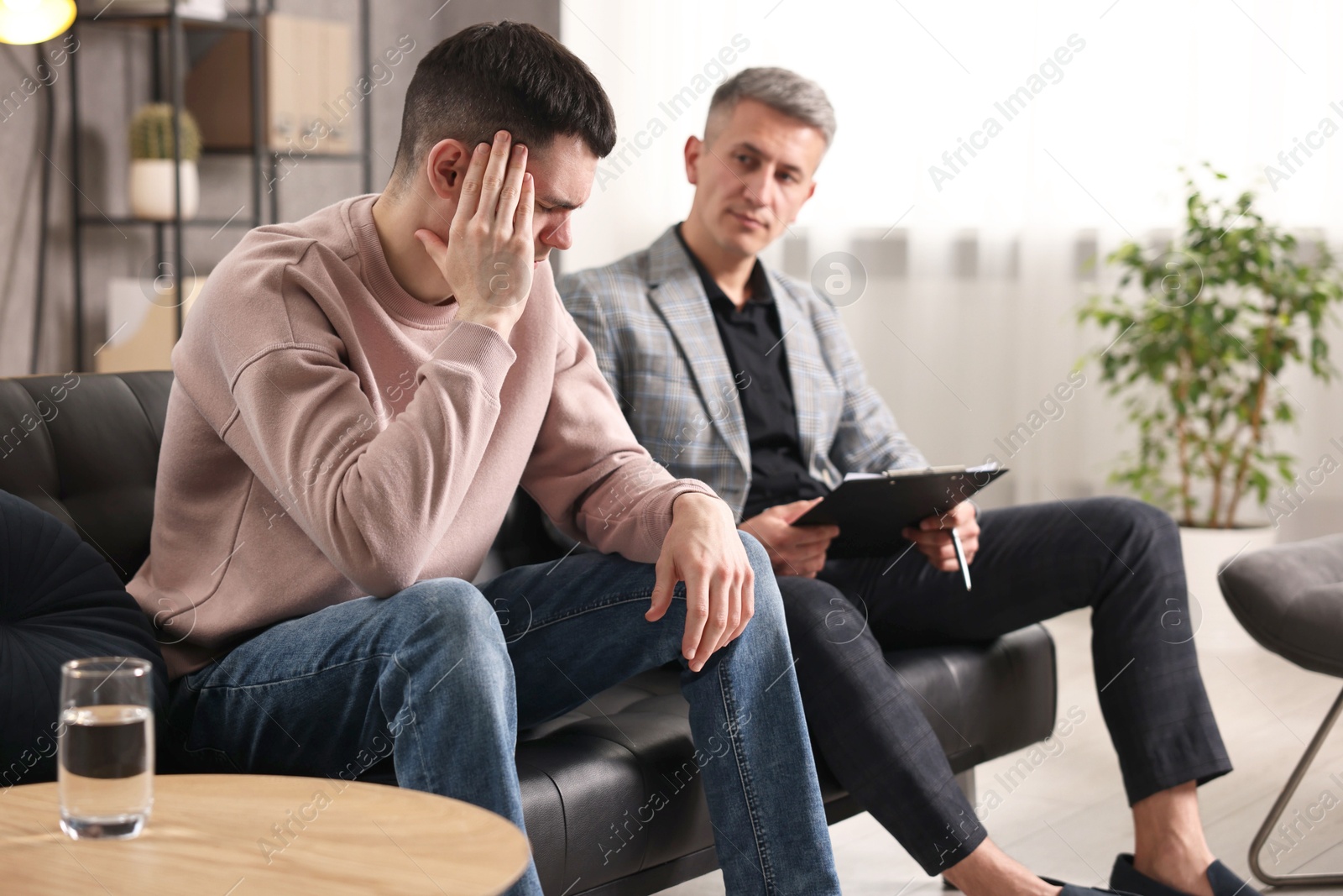 Photo of Professional psychotherapist working with patient in office