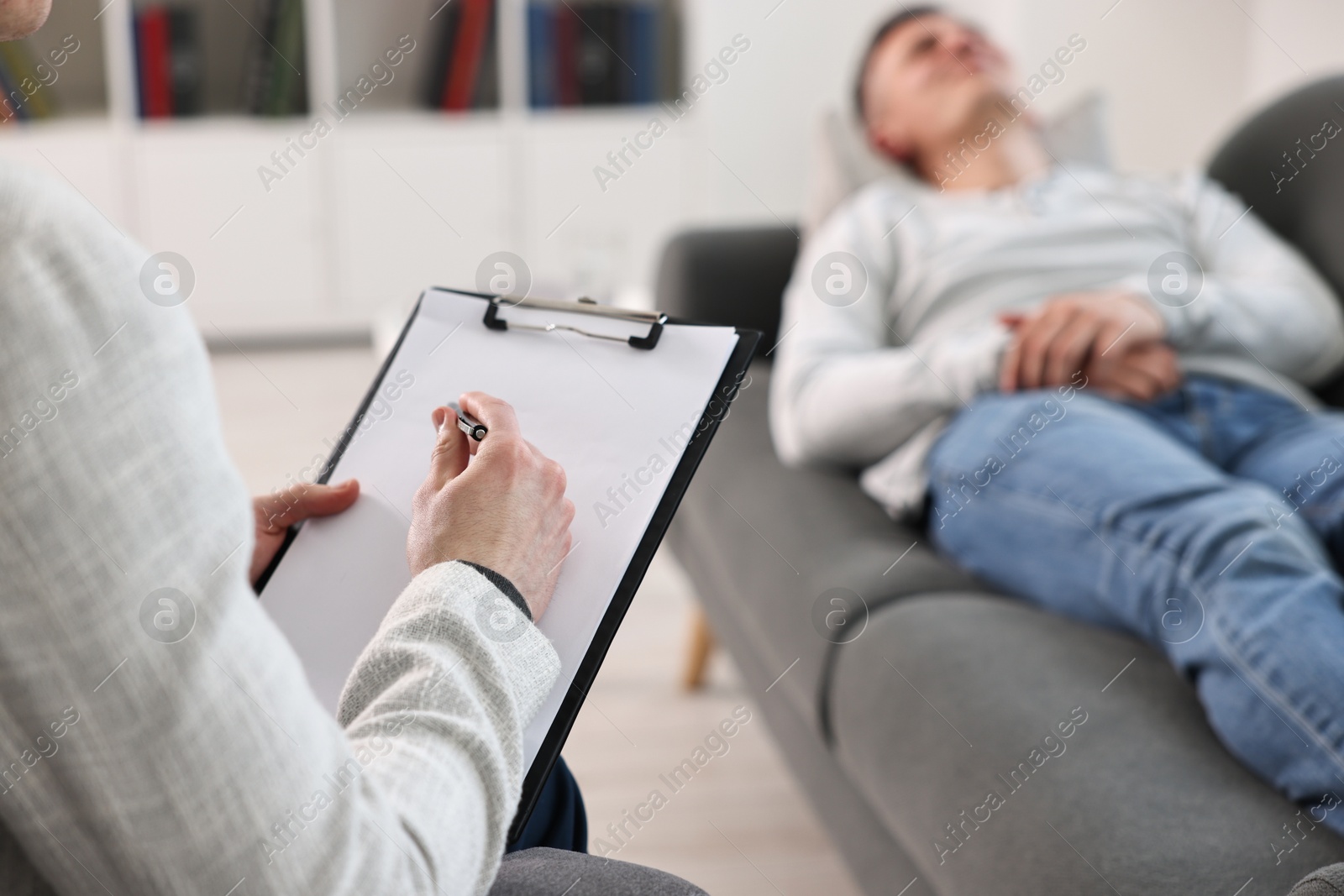 Photo of Professional psychotherapist working with patient in office, closeup