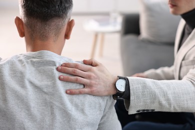 Photo of Professional psychotherapist working with patient in office, closeup