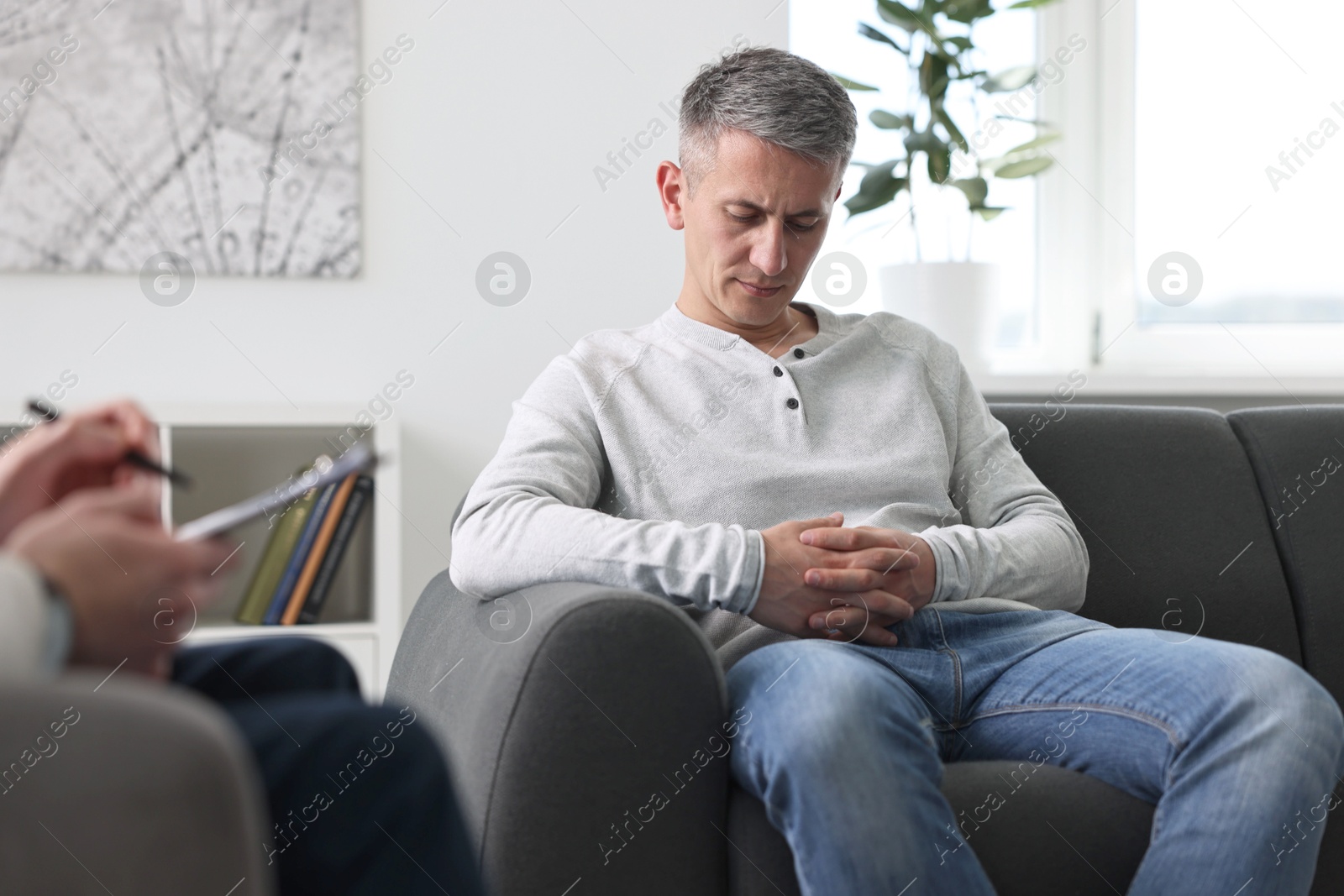 Photo of Professional psychotherapist working with patient in office