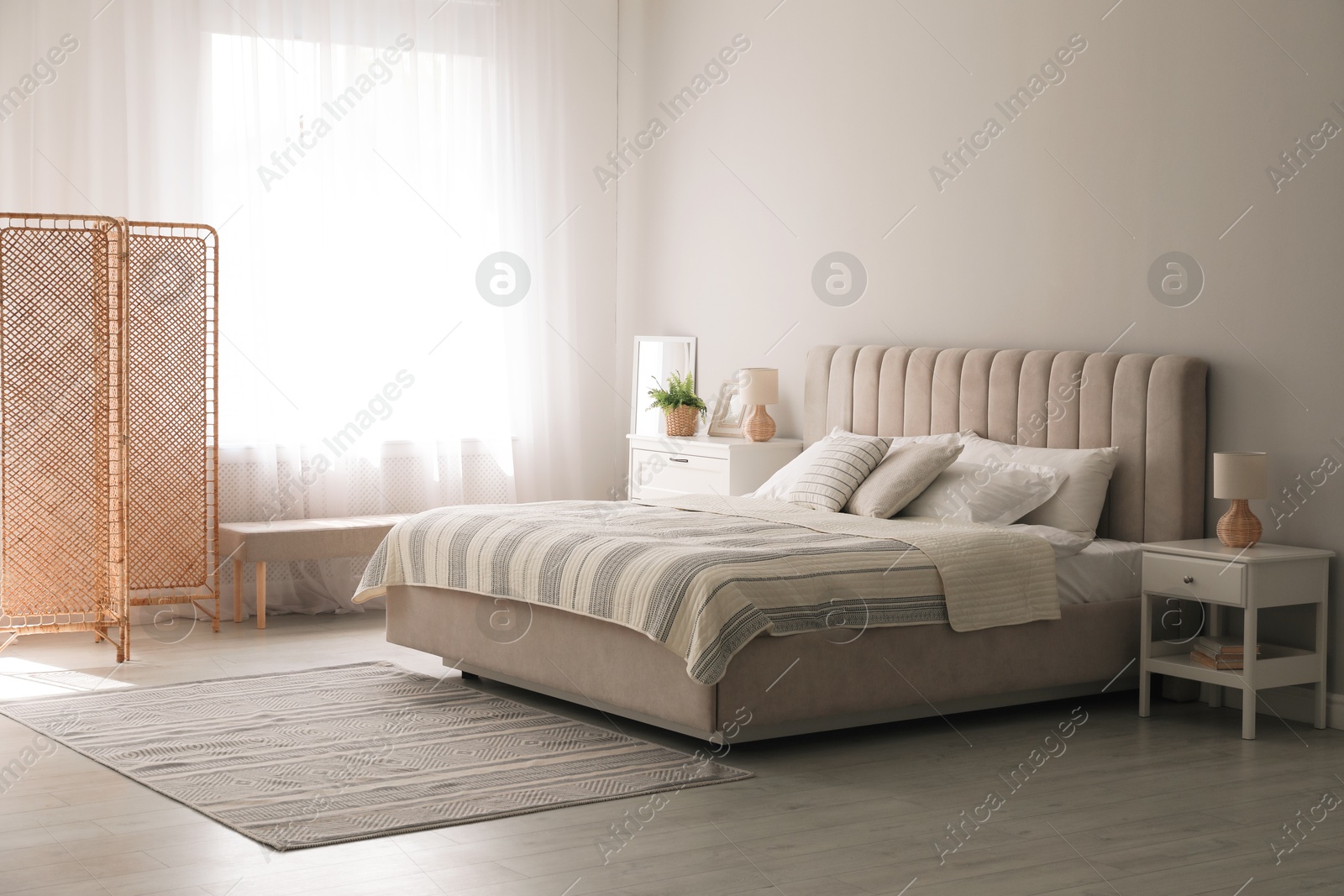 Photo of Stylish interior of contemporary bedroom with comfortable bed