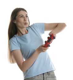 Excited woman playing video games with controller on white background