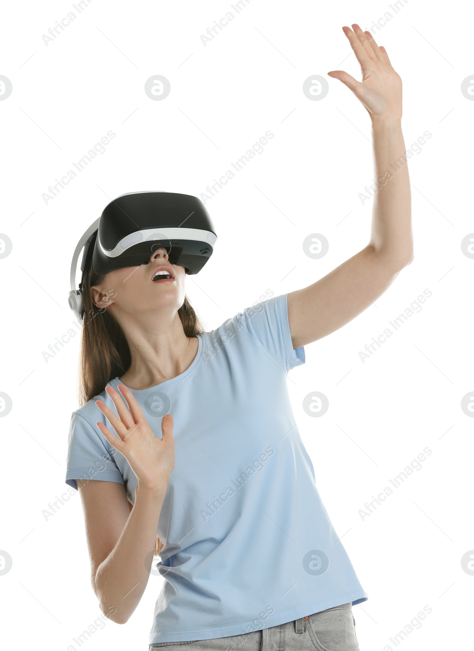 Photo of Surprised woman using virtual reality headset on white background