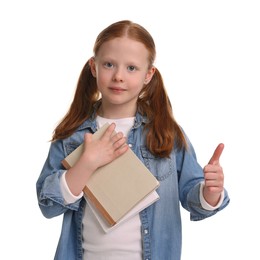 Cute little girl with books showing thumb up on white background