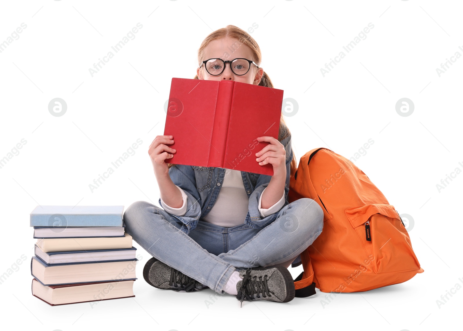 Photo of Cute little girl with stack of books and backpack on white background