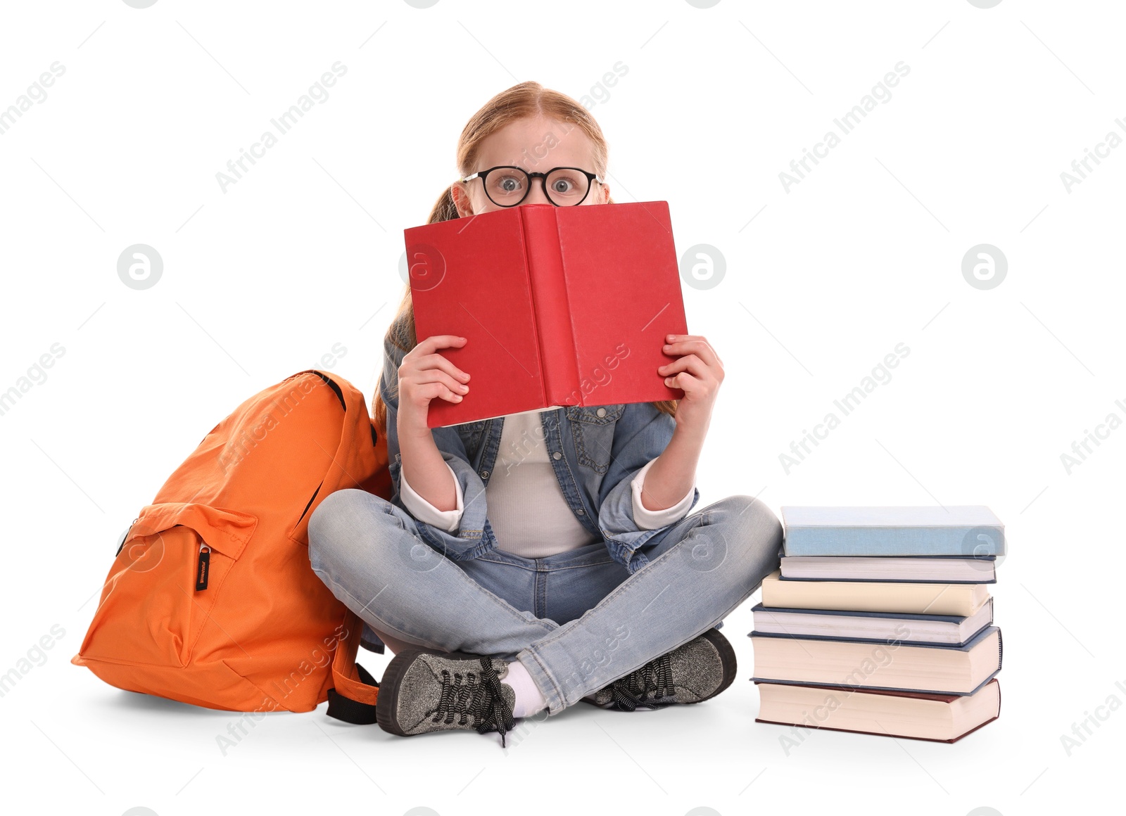 Photo of Cute little girl with stack of books and backpack on white background