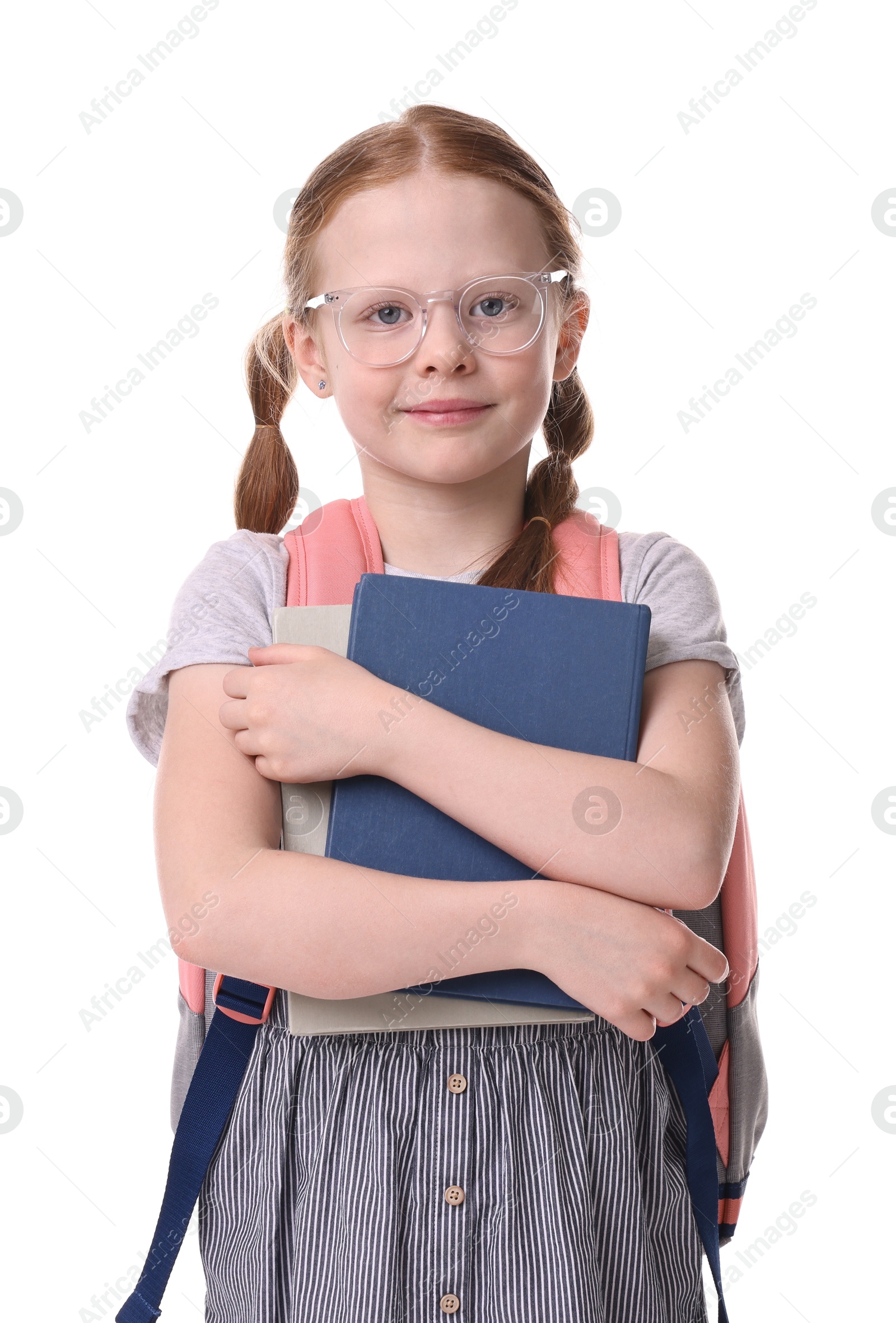 Photo of Cute little girl with books and backpack on white background