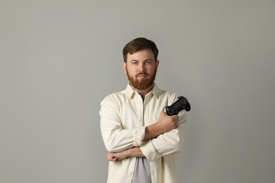 Photo of Man with game controller on grey background