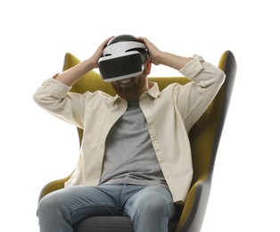 Photo of Smiling man using virtual reality headset while sitting in armchair on white background