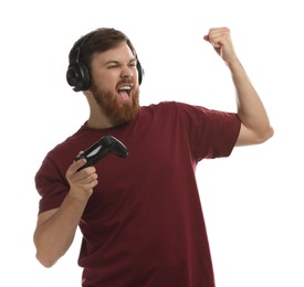Photo of Emotional man in headphones with game controller on white background