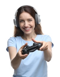 Happy woman in headphones playing video game with controller on white background