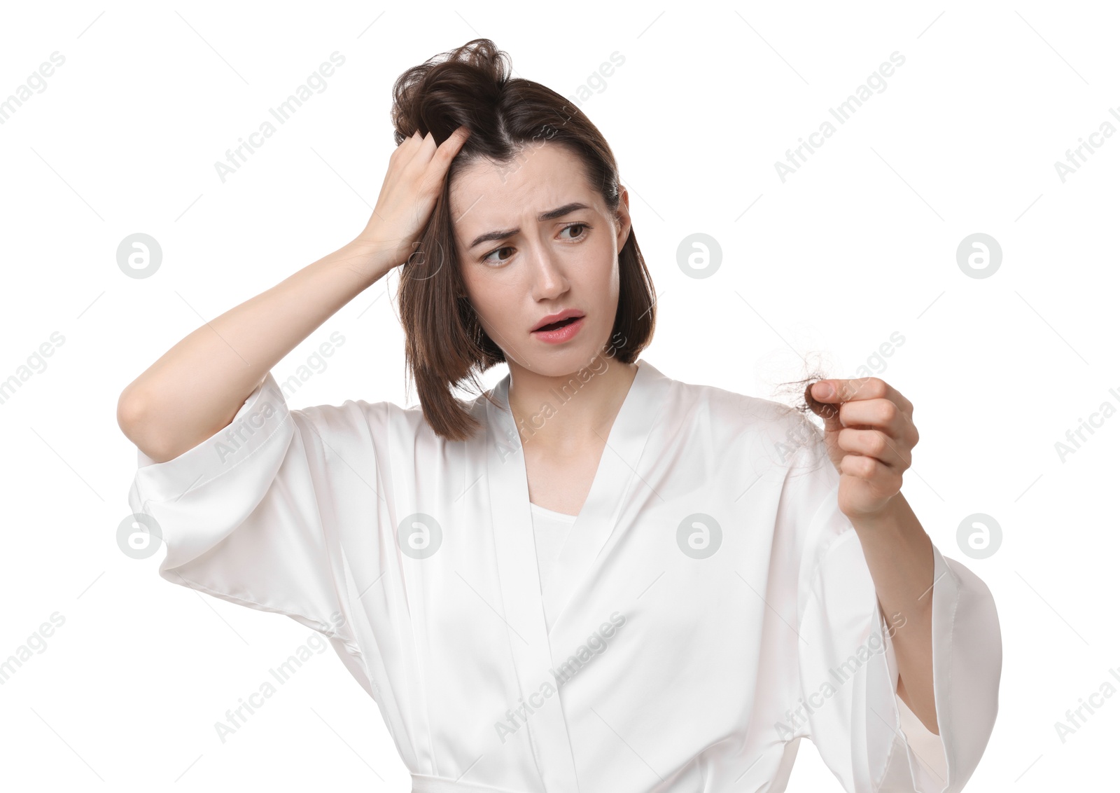 Photo of Stressed woman holding clump of lost hair on white background. Alopecia problem