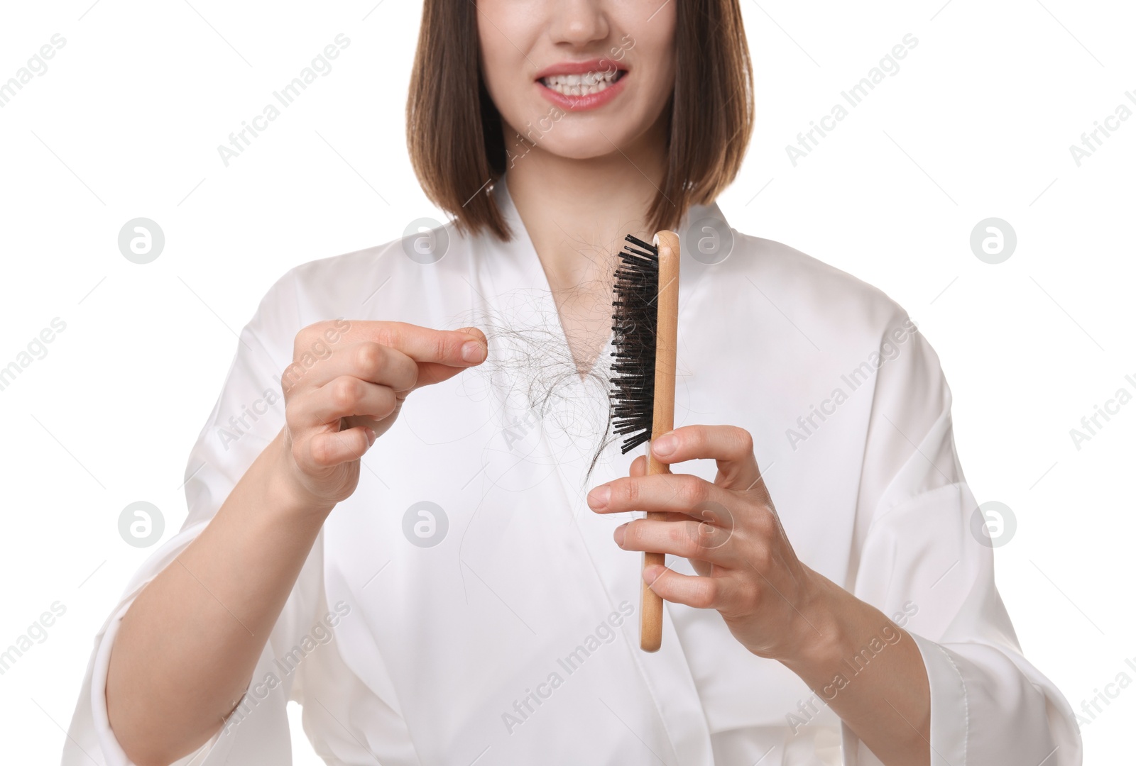 Photo of Woman taking her lost hair from brush on white background, closeup. Alopecia problem