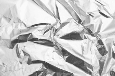 Photo of Crumpled silver foil as background, top view