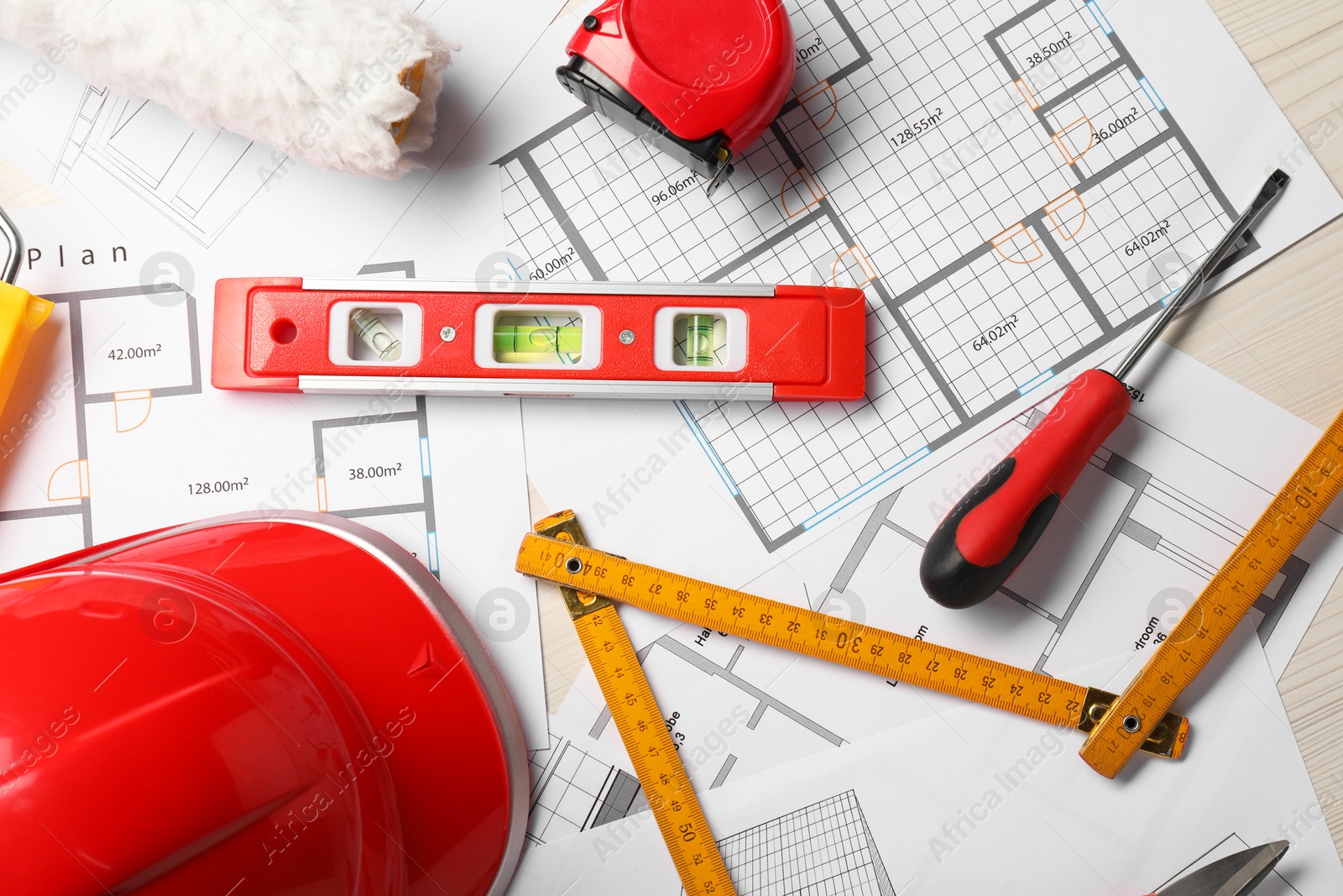 Photo of Flat lay composition with building level and other construction tools on white wooden table