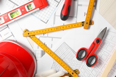 Photo of Flat lay composition with building level and other construction tools on white wooden table