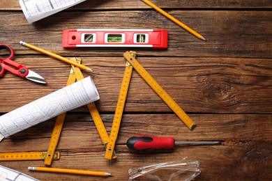 Photo of Flat lay composition with building level and other construction tools on wooden table, space for text