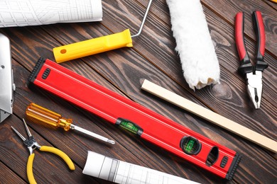 Photo of Flat lay composition with building level and other construction tools on wooden table