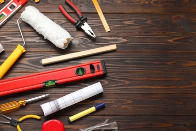 Photo of Flat lay composition with building level and other construction tools on wooden table, space for text